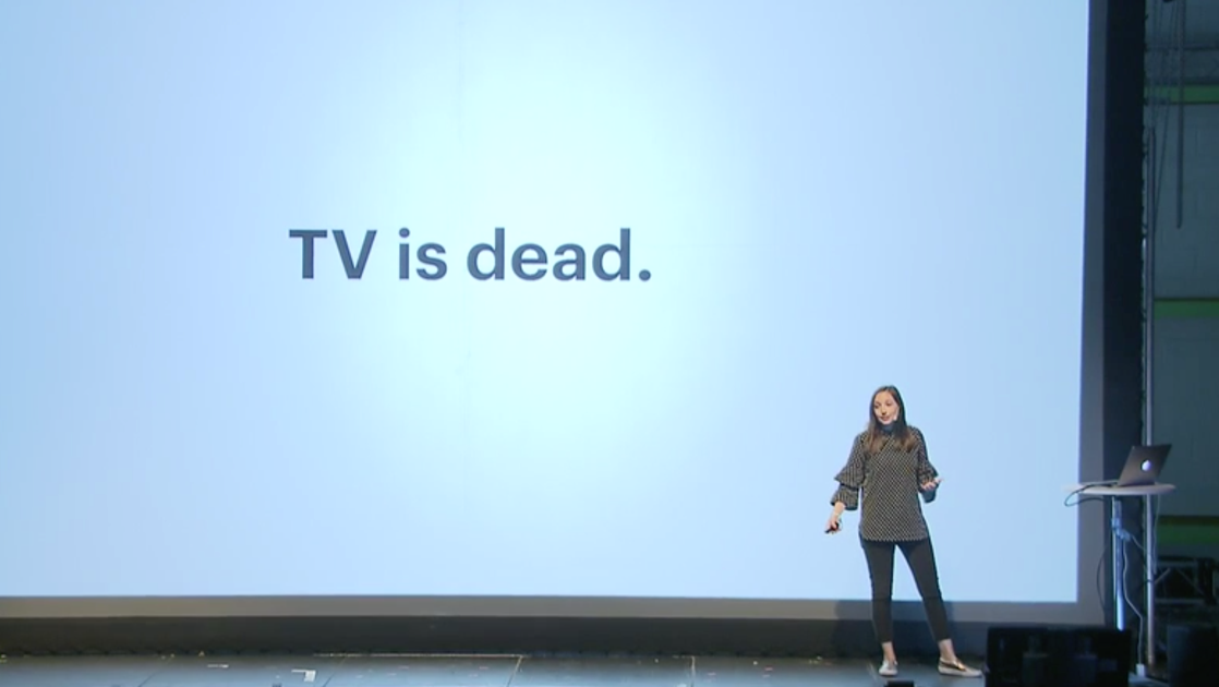 Molly speaking at Nordic.Design 2017. She is standing in front of a large screen with the words TV is Dead displayed.